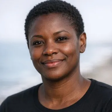 Woman in her early forties, short natural hair, warm smile, dark top